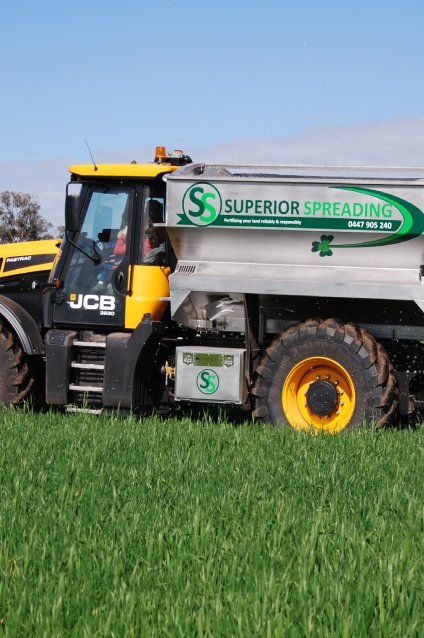 A tractor with a large tanker in a field, used for spreading lime, gypsum, and fertiliser with precise rate control.